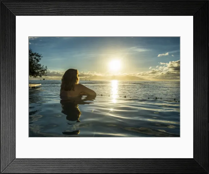 Framed Print : Woman enjoying the sunset in a swimming pool with Moorea in the background, Papeete Framed Print : Woman enjoying the sunset in a swimming pool with Moorea in the background, Papeete