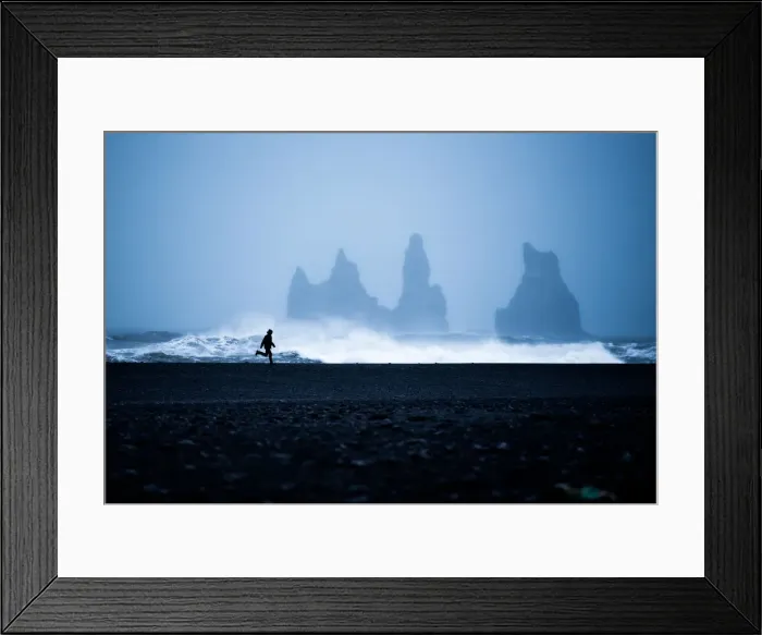 Framed Print : Tourist running on Black Sand Beach, Iceland, Polar Regions Framed Print : Tourist running on Black Sand Beach, Iceland, Polar Regions