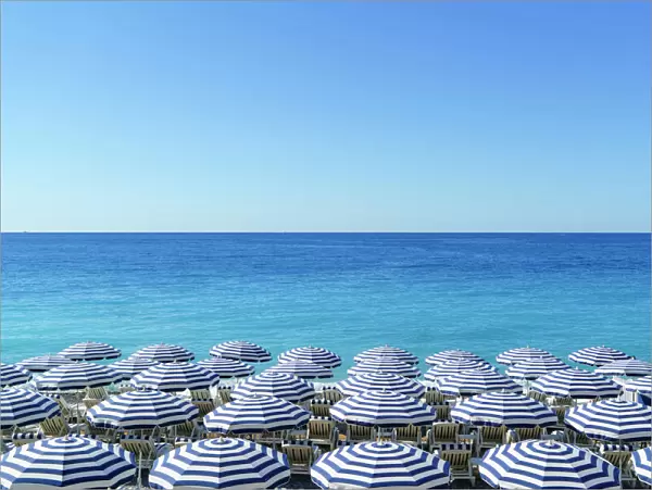 Blue and white beach parasols, Nice, Cote d Azur, Alpes-Maritimes, Provence, French Riviera