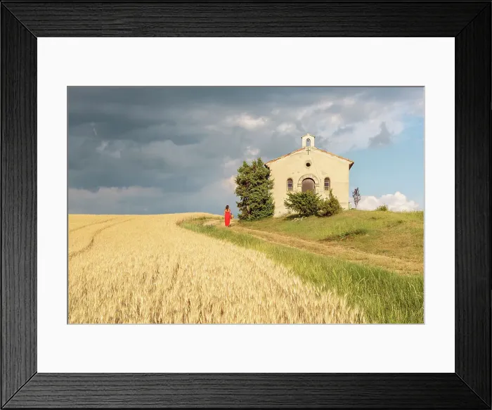 Framed Print : Woman in red dress and wicker basket passing by Notre-Dame-de-Sante chapel, Entrevennes Framed Print : Woman in red dress and wicker basket passing by Notre-Dame-de-Sante chapel, Entrevennes