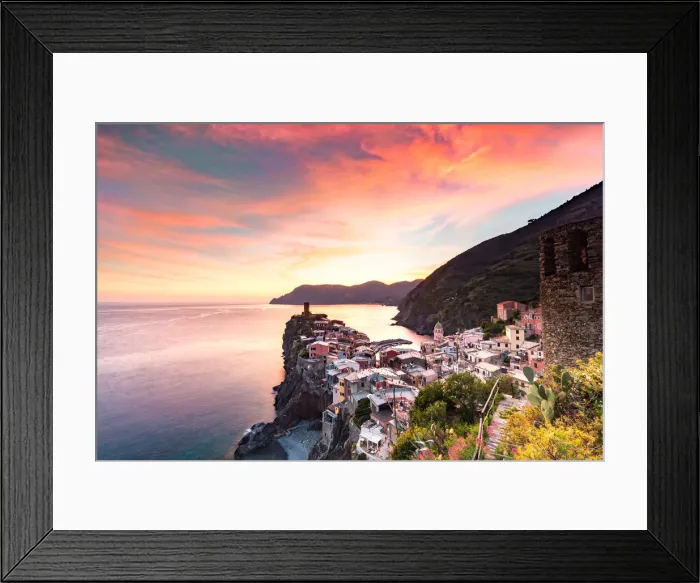 Framed Print : The setting sun lights up the sky and casts an orange glow over the old town Framed Print : The setting sun lights up the sky and casts an orange glow over the old town