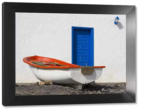 Small boat and traditional house at Playa Pozo Negro on the volcanic island of Fuerteventura