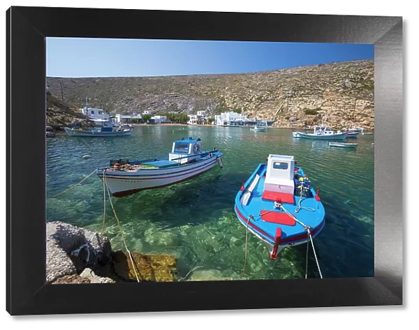 View over crystal clear water and fishing boats in harbour, Cheronissos, Sifnos, Cyclades