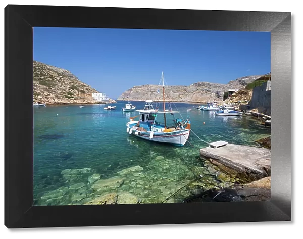 View of crystal clear water and fishing boats in harbour, Cheronissos, Sifnos, Cyclades