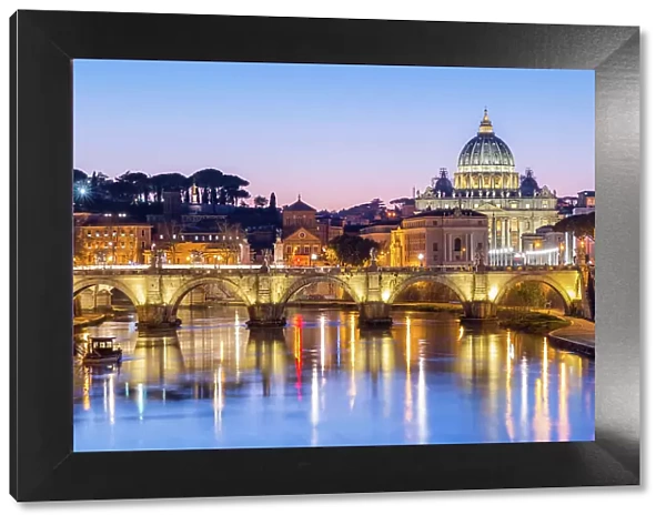 St. Peters Basilica and the Vatican with Ponte St Angelo over the River Tiber at dusk