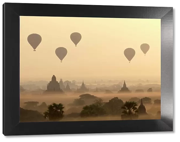 Hot air ballons fly over ancient temples at dawn in Bagan (Pagan), Myanmar (Burma), Asia