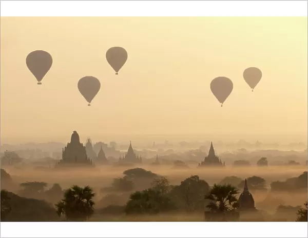 Hot air ballons fly over ancient temples at dawn in Bagan (Pagan), Myanmar (Burma), Asia