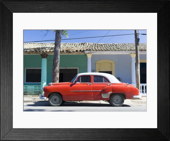 Framed Print : Red vintage American car parked on street next to colourful buildings in Vinales Framed Print : Red vintage American car parked on street next to colourful buildings in Vinales