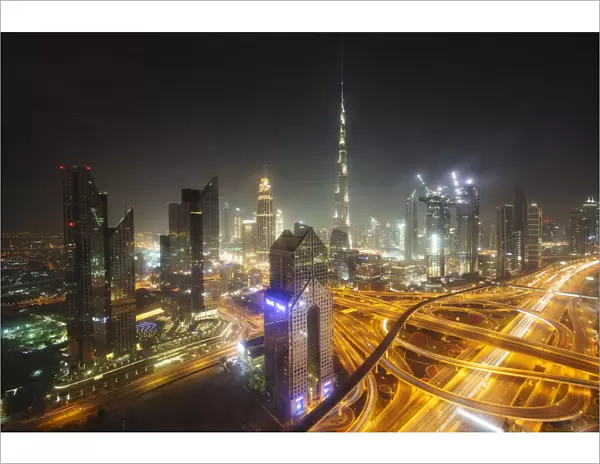 Dubai skyline and Sheikh Zayed Road Interchange by night, Dubai, United Arab Emirates