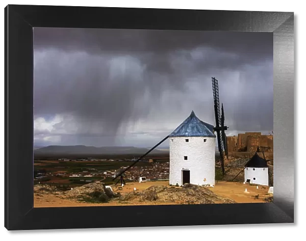 Storm clouds on windmills and castle, Consuegra, Don Quixote route, Toledo province