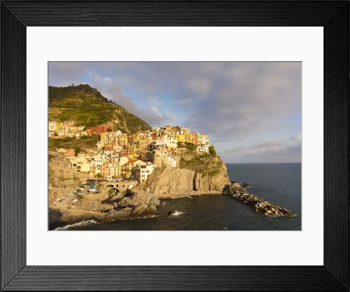 Framed Print : Afternoon sun and colourful buildings by sea in Manarola, Cinque Terre, UNESCO World Heritage Site Framed Print : Afternoon sun and colourful buildings by sea in Manarola, Cinque Terre, UNESCO World Heritage Site