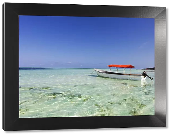 Small boat in crystal clear water, Pingwe, Island of Zanzibar, Tanzania, East Africa