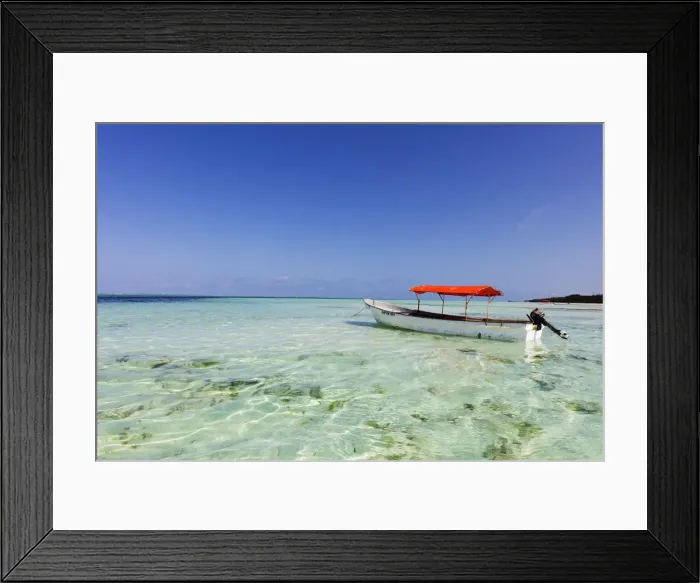 Framed Print : Small boat in crystal clear water, Pingwe, Island of Zanzibar, Tanzania, East Africa Framed Print : Small boat in crystal clear water, Pingwe, Island of Zanzibar, Tanzania, East Africa
