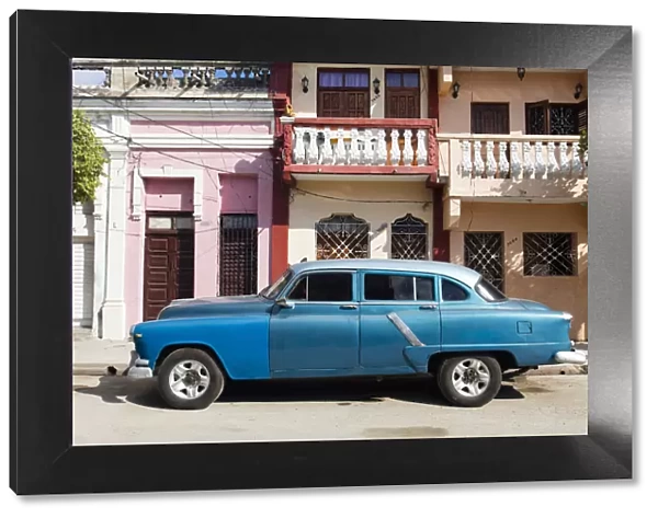 Old blue American car parked in front of old buildings, Cienfuegos, UNESCO World Heritage Site