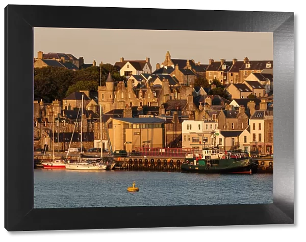 Lerwick, from the sea, waterfront sandstone buildings and golden early morning, Shetland Islands
