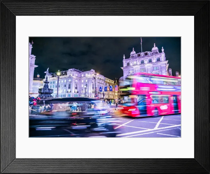 Framed Print : A bus and taxi zoom round Piccadilly Circus, London, England Framed Print : A bus and taxi zoom round Piccadilly Circus, London, England