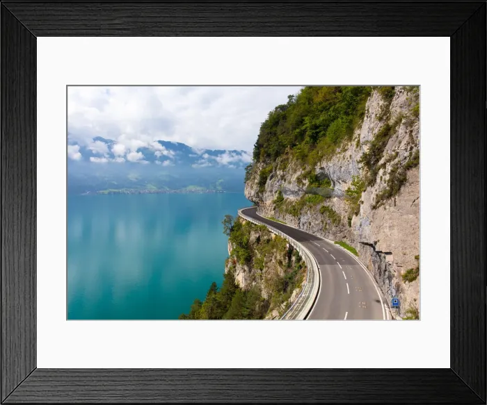 Framed Print : A curved road built into the side of a mountain next to Lake Thun, Interlaken, Bernese Oberland Framed Print : A curved road built into the side of a mountain next to Lake Thun, Interlaken, Bernese Oberland