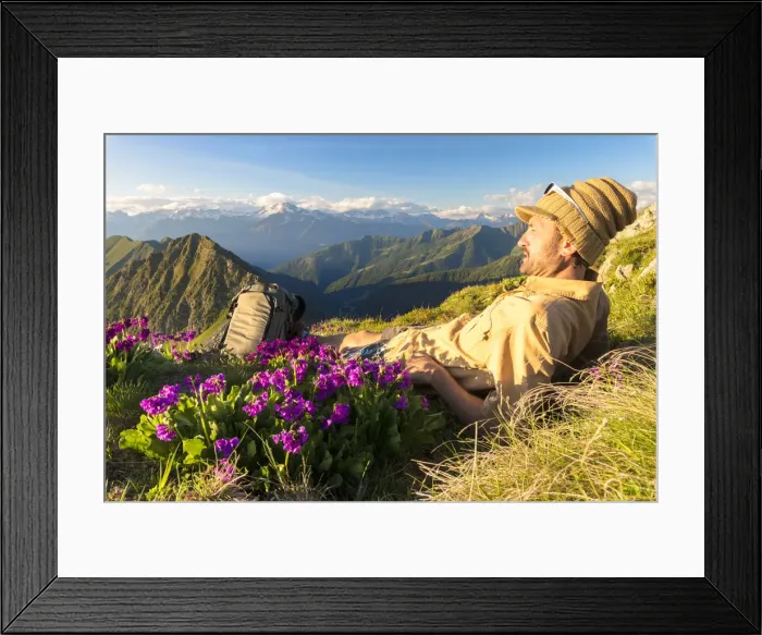 Framed Print : Man lying down on top of Monte Azzarini looks to Monte Disgrazia and Monte Pedena Framed Print : Man lying down on top of Monte Azzarini looks to Monte Disgrazia and Monte Pedena