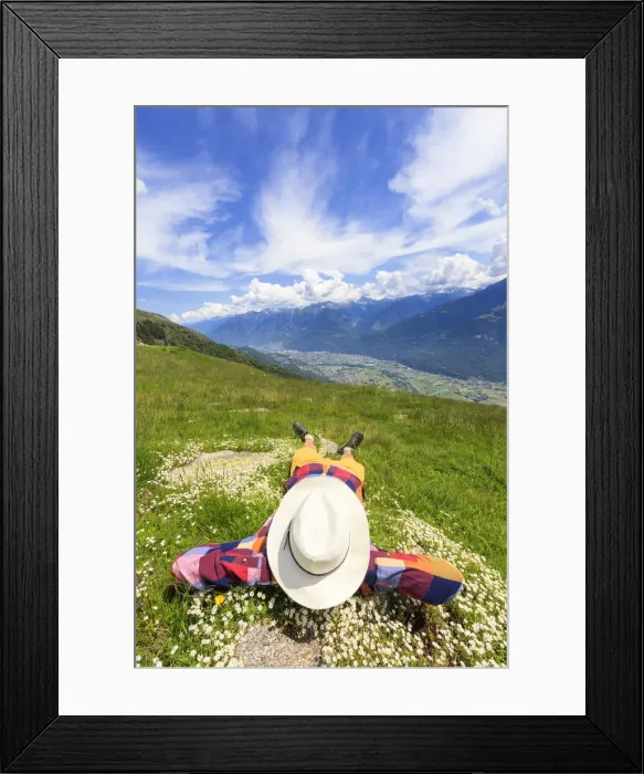 Framed Print : Rear view of man with hat lying on grass, Alpe Bassetta, Valtellina, Sondrio, Lombardy Framed Print : Rear view of man with hat lying on grass, Alpe Bassetta, Valtellina, Sondrio, Lombardy