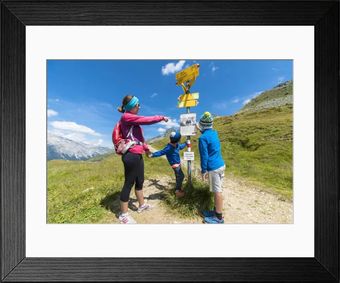 Framed Print : Mother and sons look at the signpost of hiking trails, Spluga Pass, Chiavenna Valley Framed Print : Mother and sons look at the signpost of hiking trails, Spluga Pass, Chiavenna Valley
