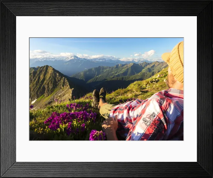 Framed Print : Man lying down on top of Monte Azzarini looks to Monte Disgrazia and Monte Pedena Framed Print : Man lying down on top of Monte Azzarini looks to Monte Disgrazia and Monte Pedena