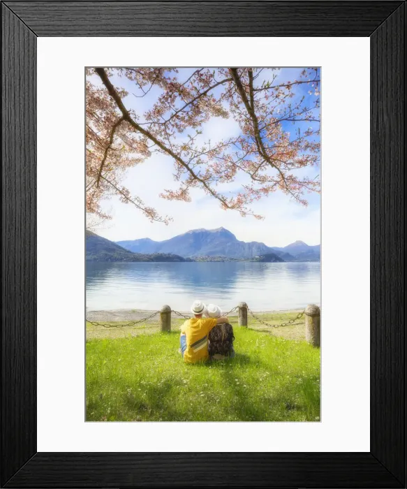 Framed Print : Couple of tourists sitting in front the lake. Lierna, Province of Lecco, Como Lake Framed Print : Couple of tourists sitting in front the lake. Lierna, Province of Lecco, Como Lake