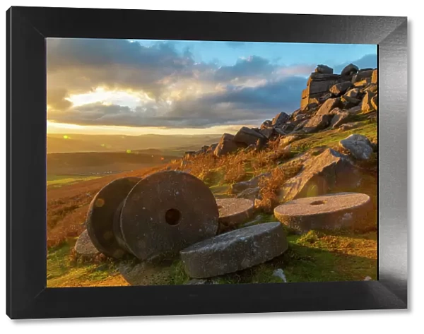 View of sunset and old millstones at Curbar Edge during autumn, Derbyshire, Peak