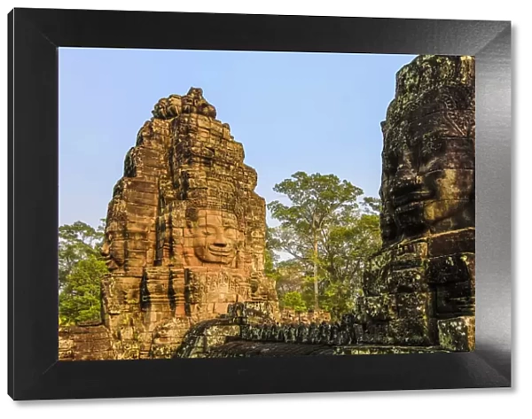 Towers and three of the 216 smiling sandstone faces at 12th century Bayon temple