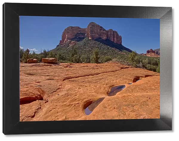 Reflections of Courthouse Butte in the Slick Rock Bowls along the Llama Trail in Sedona