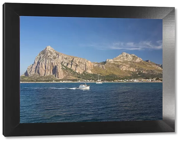 View across the bay to Monte Monaco and Pizzo di Sella, small boat returning to port