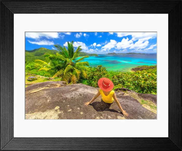 Framed Print : Panorama with woman looking to Cote d Or Bay, with Curieuse, St Framed Print : Panorama with woman looking to Cote d Or Bay, with Curieuse, St