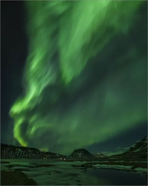 Aurora borealis (Northern Lights) and partially frozen lake, North Snaefellsnes, Iceland