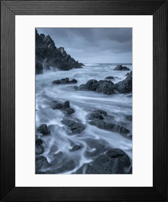 Framed Print : Swirling waves over dark rocks in a rugged North Devon cove, Devon, England, United Framed Print : Swirling waves over dark rocks in a rugged North Devon cove, Devon, England, United