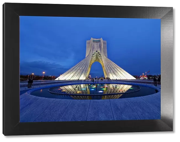 Azadi Tower (Freedom Monument) and cultural complex reflecting in a pond at sunset