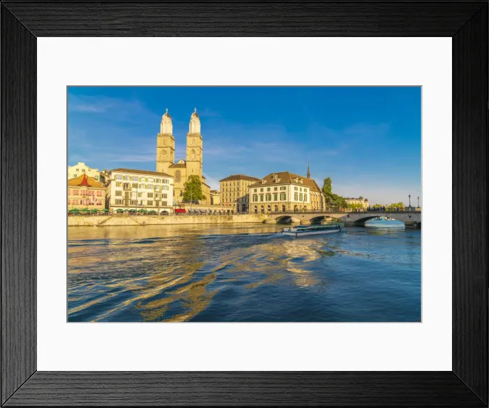 Framed Print : Ferry along Limmat River next to Munsterbrucke bridge with Grossmunster in background Framed Print : Ferry along Limmat River next to Munsterbrucke bridge with Grossmunster in background