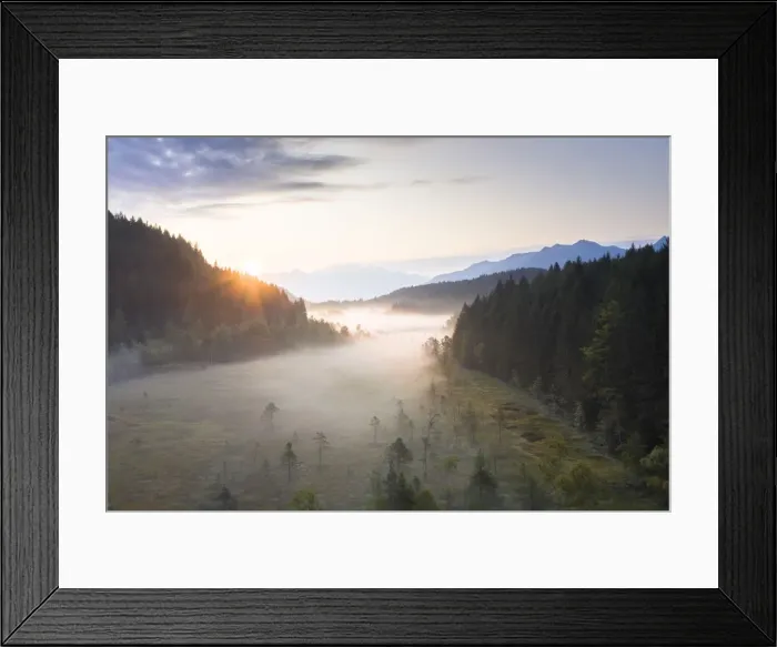 Framed Print : Sun rays at sunrise on fog covering the wetland of Pian di Gembro Reserve, aerial view