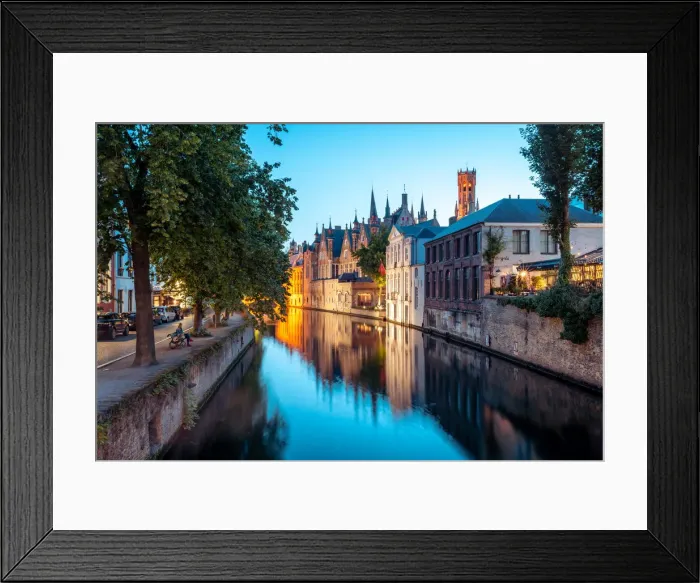 Framed Print : A tranquil canal scene in Bruges, with the spires of the Stadhuis (Town Hall) in