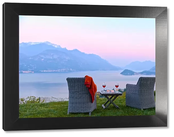 Armchairs and red wine with views of Lake Como at sunset, Lombardy, Italian Lakes