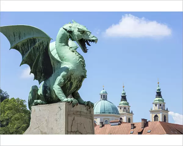Dragon statue on the Dragon Bridge (Zmajski most) in front of the Ljubljana Cathedral