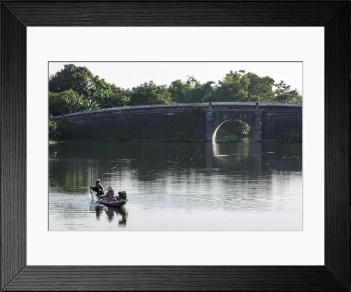 Framed Print : A man and woman fishing from a small boat in the moat around the Citadel in Hue, Vietnam Framed Print : A man and woman fishing from a small boat in the moat around the Citadel in Hue, Vietnam