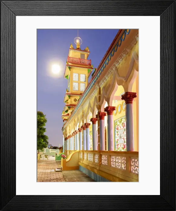 Framed Print : The Cao Dai temple in Vung Tau lit up at dusk with the full moon to the left of the tower Framed Print : The Cao Dai temple in Vung Tau lit up at dusk with the full moon to the left of the tower