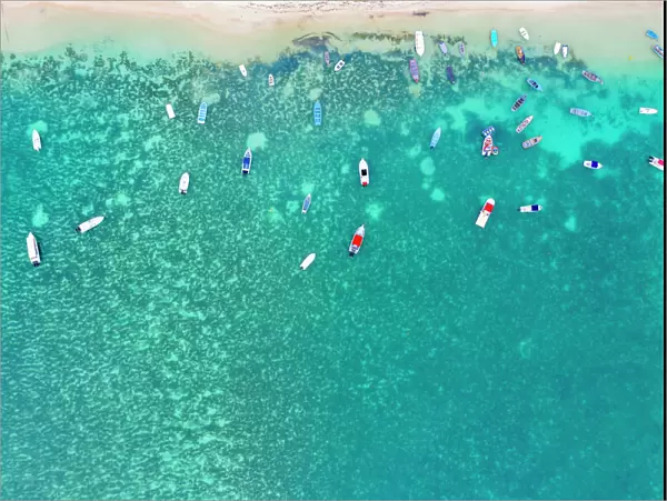Aerial by drone of boats in the turquoise water of lagoon front of Mont Choisy beach