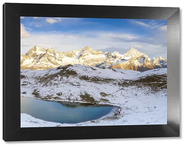 Aerial panoramic of Riffelsee lake surrounded by snow, Zermatt, canton of Valais