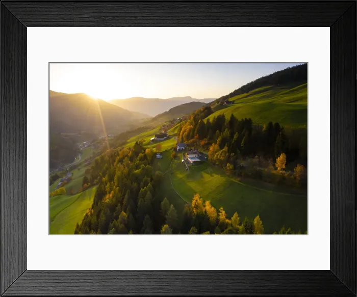 Framed Print : Sunbeam at sunset lighting the warm colors of autumn in Funes Valley, aerial view Framed Print : Sunbeam at sunset lighting the warm colors of autumn in Funes Valley, aerial view