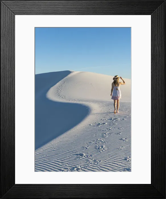 Framed Print : A woman walking along thes curve of a dunes ridge in White Sands National Park Framed Print : A woman walking along thes curve of a dunes ridge in White Sands National Park
