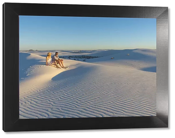 A couple enjoys White Sands National Park at sunset, New Mexico, United States of America