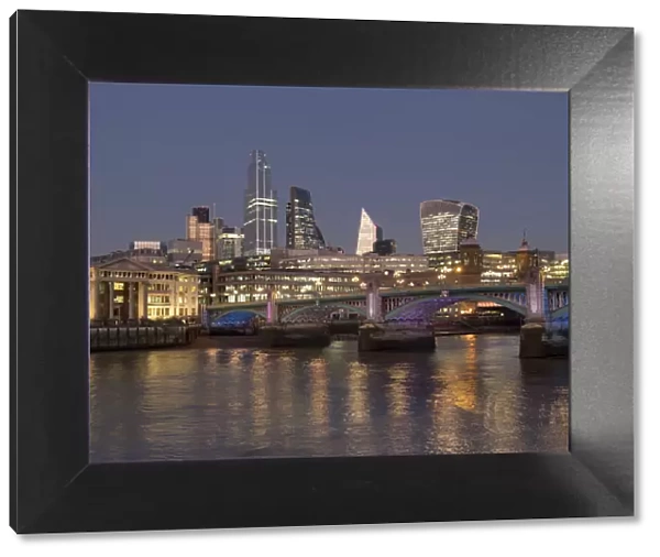 Cityscape with complete 22 Bishopsgate Tower and Southwark Bridge at dusk, London