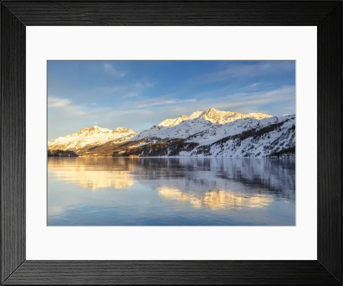Framed Print : Mountains illuminated by sun at sunset reflected on the icy surfaces of Lake Sils