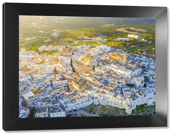 Aerial view by drone of the old town of Ostuni at sunset, Apulia, Italy, Europe
