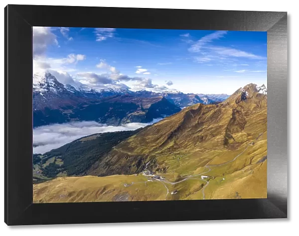 Aerial panoramic of Eiger and sea of clouds surrounding First and Grindelwald in autumn